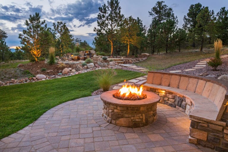 Outdoor patio with decorative concrete landscape edging and fire pit area in Vienna, VA